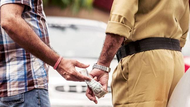 What are the charges and penalties for bribing a police officer?